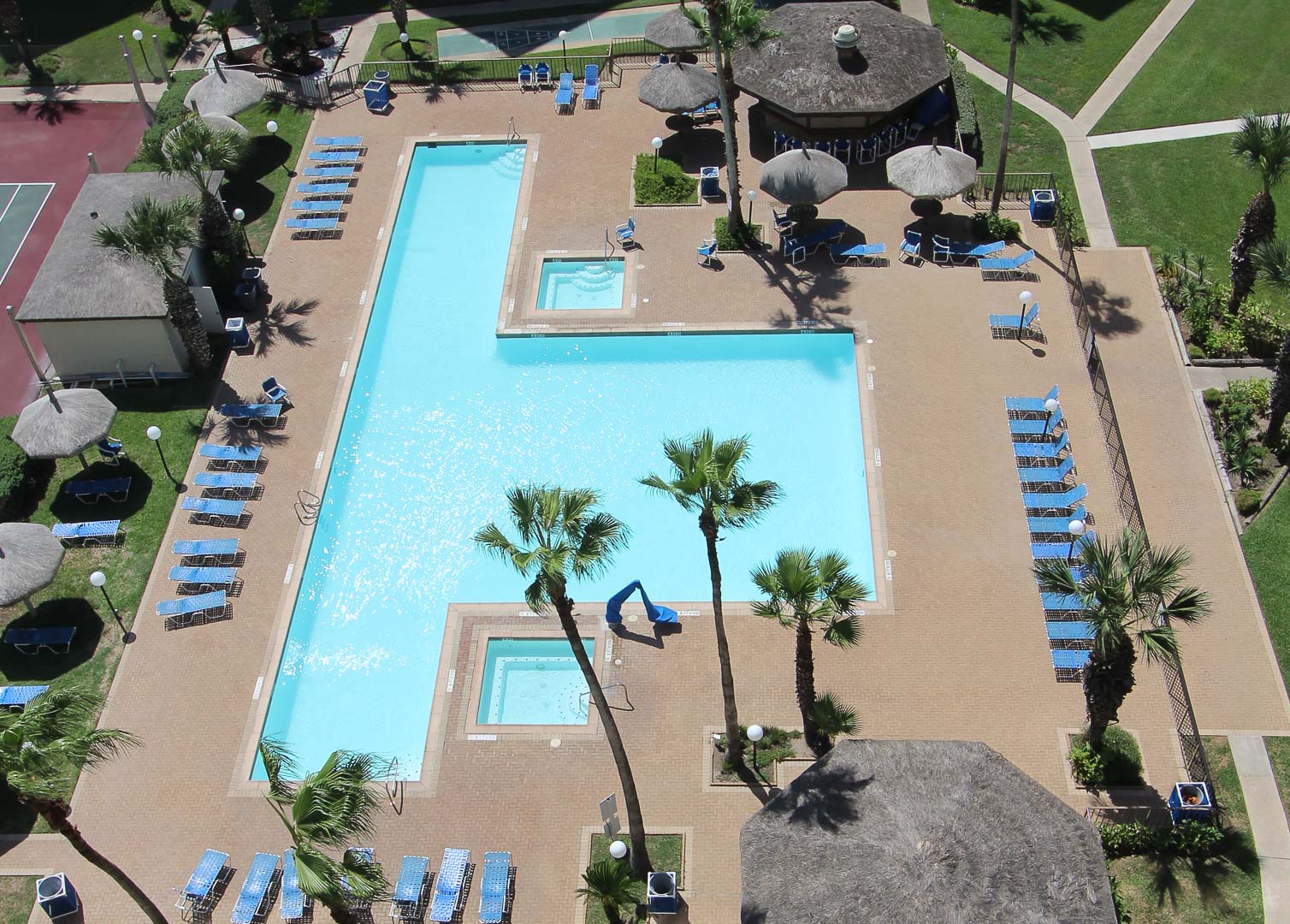 An outdoor swimming pool at VRI's Royale Beach and Tennis Club.